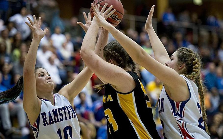 Vicenza's Adrianna Lovelace tries to keep the ball away from Ramstein's Bella Rodriguez, left, and Lindsey Breton during the DODDS-Europe Division I championship game in Wiesbaden, Germany, Saturday, Feb. 27, 2016. Vicenza lost to Ramstein in overtime 49-46. 