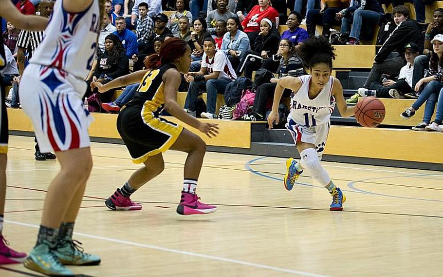 Ramstein's Desiree Palacios dribbles around Vicenza's DeAsia Fairley during the DODDS-Europe Division I championship game in Wiesbaden, Germany, Saturday, Feb. 27, 2016. Ramstein beat Vicenza 49-46 in overtime to win the title. 