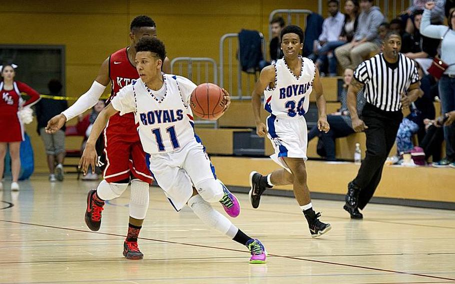 Ramstein's D'Angelo Griggs dribbles past Kaiserslautern's Glen Alexander Jr. during the DODDS-Europe Division I championship game in Wiesbaden, Germany, Saturday, Feb. 27, 2016. Ramstein beat Kaiserslautern 54-46 to win the title. 