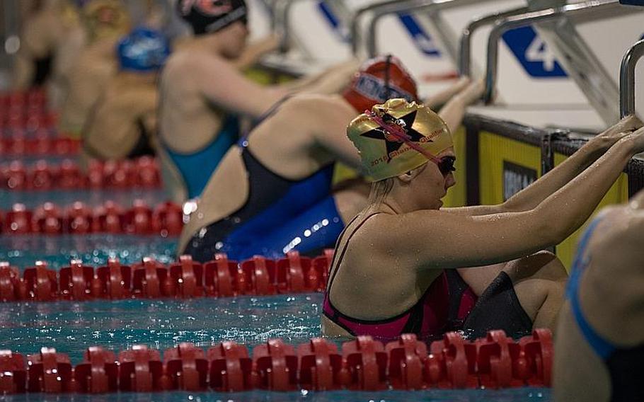 Kaiserslautern's Emma Thomas and the rest of the competitors in the girls 17-19 year-old backstroke prepare to launch themselves backwards. Thomas and the rest were participating in the second and final day of the 2016 European Forces Swim League championships held in Eindhoven, Netherlands, Sunday, Feb. 28, 2016. 