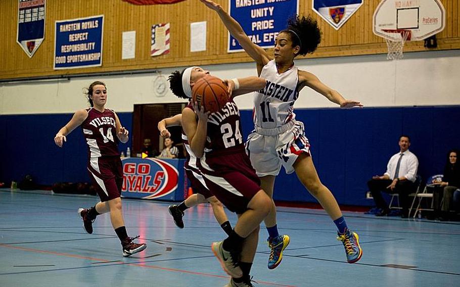 Ramstein Royal Desiree Palacios tries to block Vilseck Falcon Michaela Lewis during a game at Ramstein Air Base, Germany, on Friday, Dec. 4, 2015.