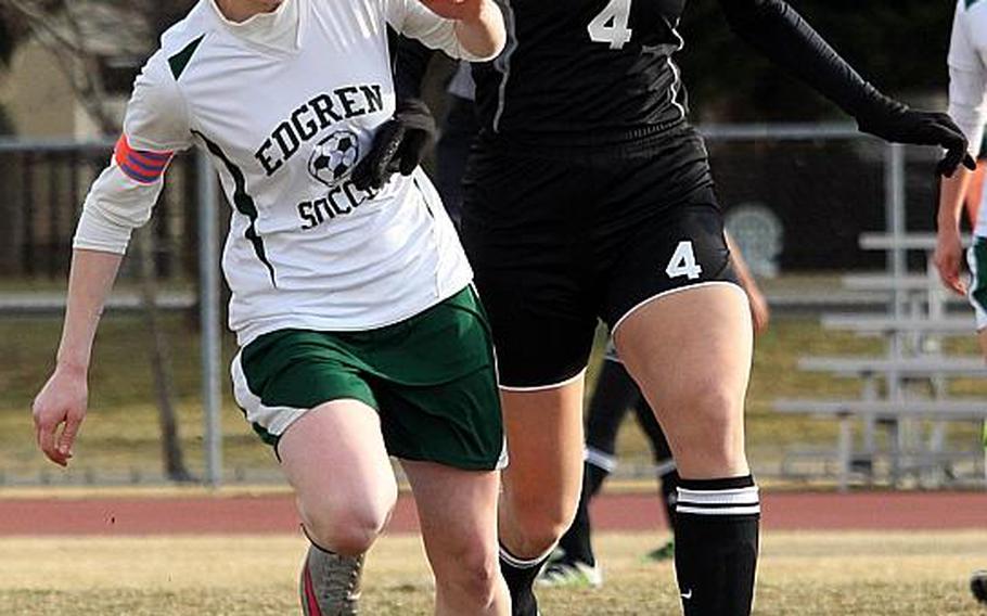 Edgren's Lizzy Long, left, and Zama's Georgia Tsitiridis chase the ball during a soccer match last week. Tsitiridis and fellow sophomore Rachel Norton have combined for 22 goals this season for the Trojans, who take on Matthew C. Perry this weekend.