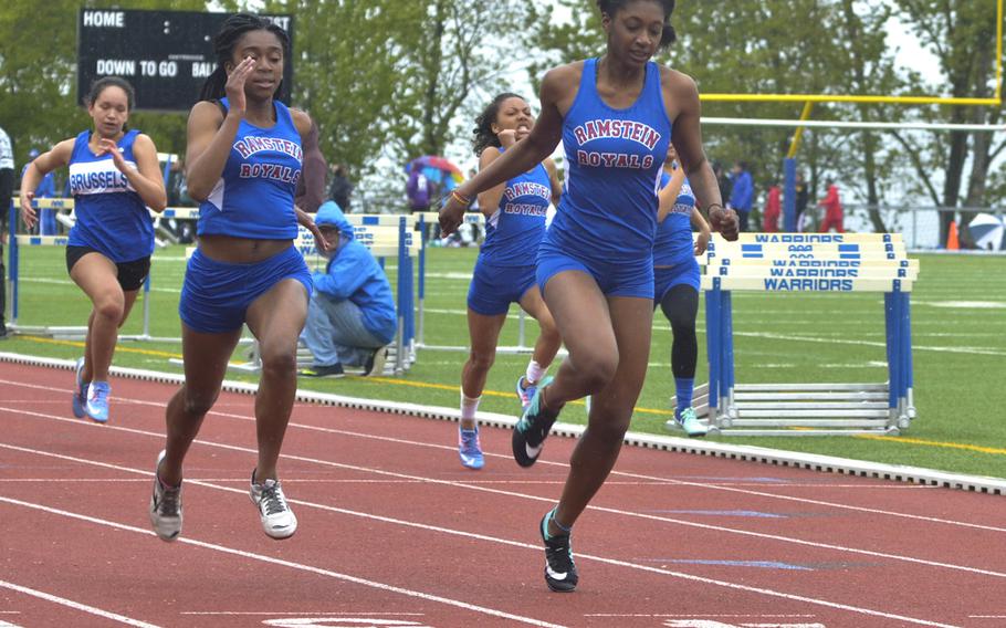 Ramstein's Denee Lawrence crosses the finish line first in the girls' 100-meter dash during a ten-team meet at Wiesbaden, Saturday, April 23, 2016. Lawrence and Ramstein also took top honors in the 4x100-meter relay.