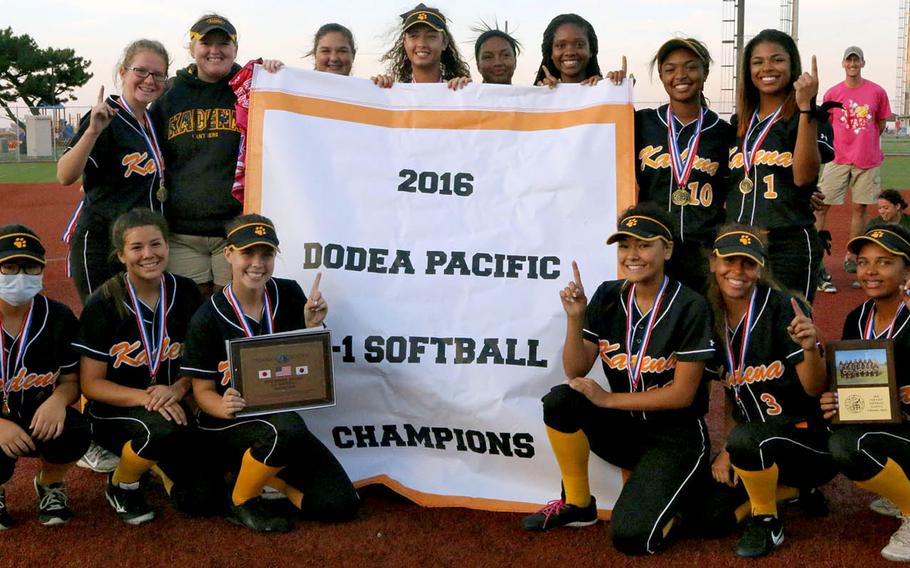 Kadena players gather 'round the banner, celebrating their third straight Far East Division I Tournament title and fourth in the last five years.