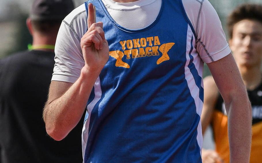 Yokota's Daniel Galvin signals his first place finish in the boys' 1,600 meter final at the Far East Track Championships at Yokota Air Base, Japan on Thursday, May 19, 2016.