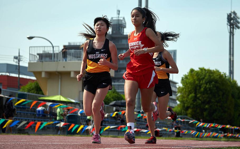Nile C. Kinnick's Arlene Avalos, right, and ASIJ's Lisa Watanuki continued their rivalry in the in the 1,600 meter final during the Far East Track Championships on Thursday, May 19, 2016 at Yokota Air Base, Japan. Avalos finished in first.