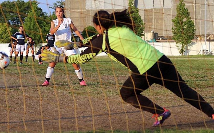 Yokota's Regina Dukat watches as her shot tails away from Osan goalkeeper Michele Thompson during Thursday's championship match penalty-kick shootout.
