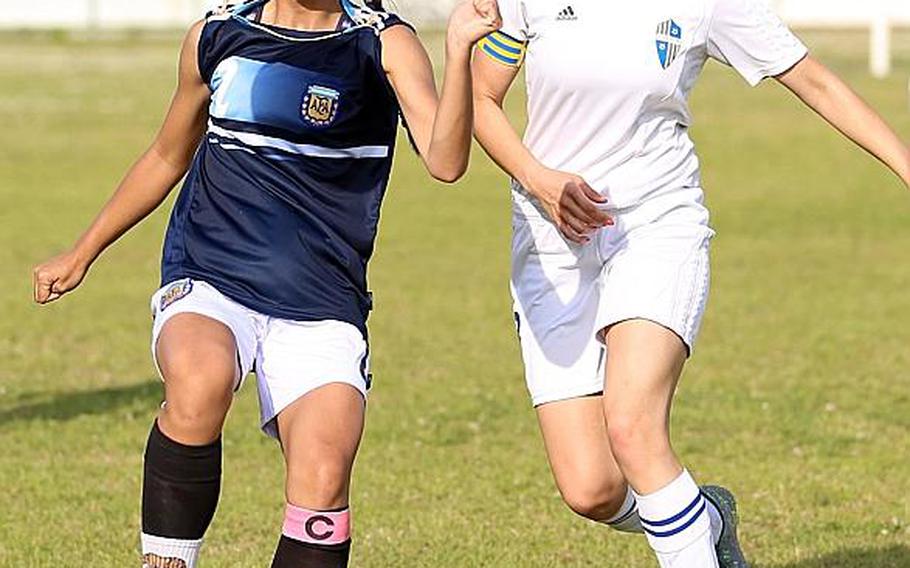 Osan's Andrea Carandang tries to play the ball as Yokota's Heather Adams moves in.
