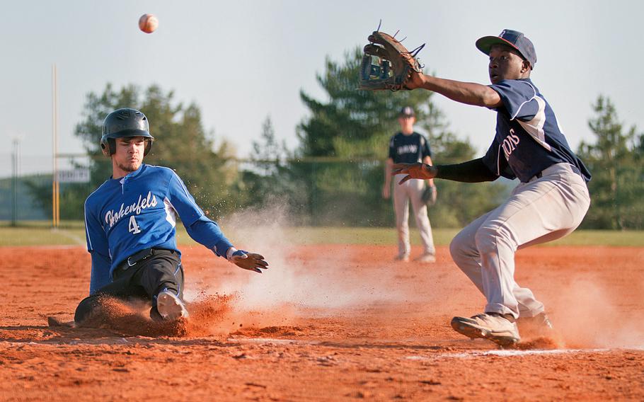 Hohenfels' Jared Johnson slides in as Bitburg's Jermain Cooks waits for the throw to arrive during a DODEA-Europe doubleheader at Hohenfels, Germany, Friday, May 6, 2016.