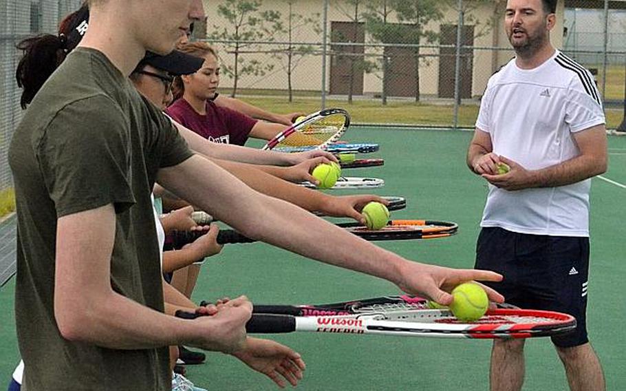 Humphreys tennis players begin a hand-eye coordination drill under the watchful eye of new Blackhawks tennis co-coach Matt Pollack.