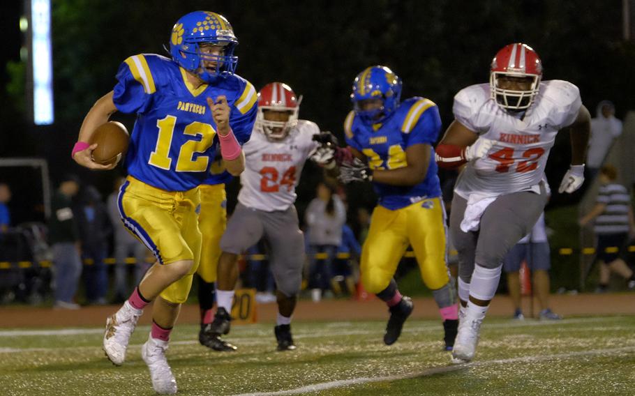 Yokota quarterback T.J. Reney scrambles out of the pocket during the Panthers' homecoming game against the Kinnick Devils Friday, Oct. 7, 2016, at Yokota Air Base, Japan. Yokota would lose 35-0.