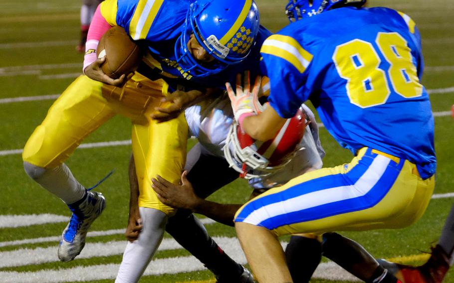 Yokota running back C.J. Thomas fights through a Kinnick defender during the Panthers' homecoming game against the visiting Devils Friday, Oct. 7, 2016, at Yokota Air Base, Japan. Yokota would be shut out for the first time in seven years in the 35-0 loss.