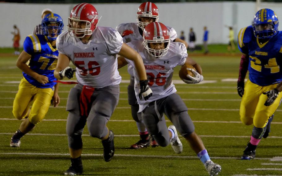 Kinnick running back Harry Cheng follows his lead blocker, Cameron Joley, for a long run up the middle during the Devils' 35-0 rout over the host Yokota Panthers Friday, Oct. 7, 2016, at Yokota Air Base, Japan.