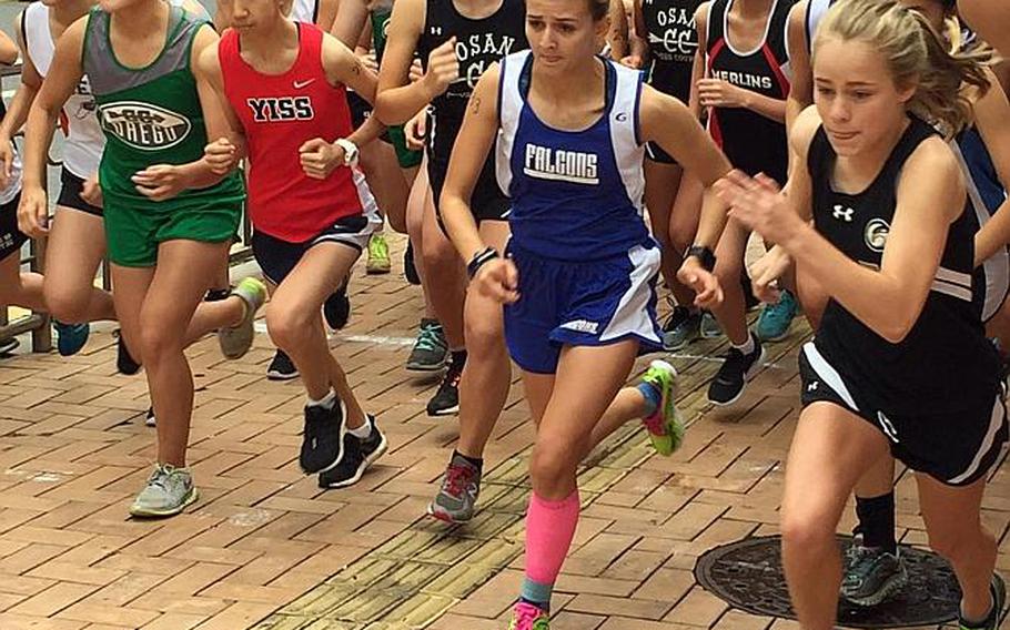 Sarah Francis, a Humphreys sophomore, breaks out at right at the start of the Korean-American Interscholastic Activities Conference championship on Saturday at Camp Humphreys. Francis won her first career race in 20 minutes, 42 seconds, for the district title.