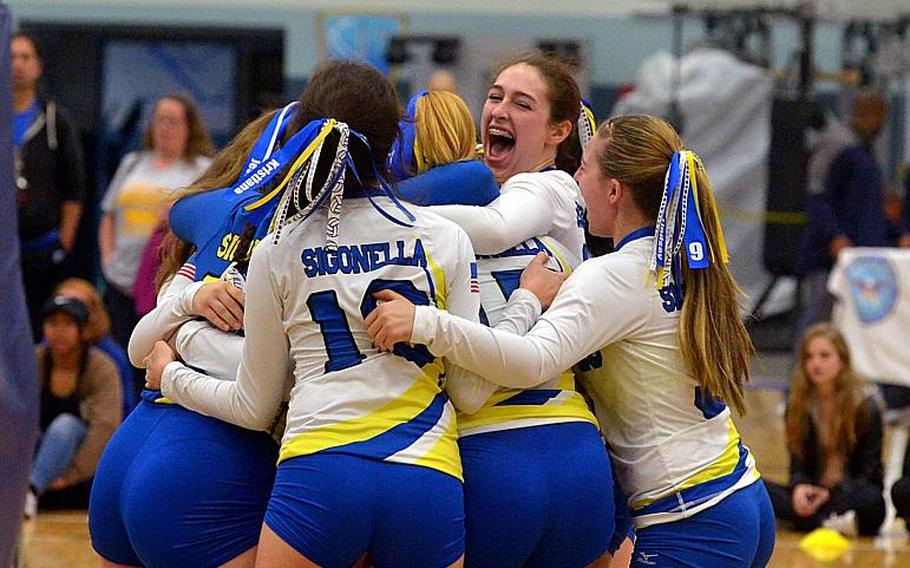 The Sigonella Dragons celebrate their 25-11, 25-21, 25-16 win over Baumholder in the Division III final at the DODEA-Europe volleyball championships in Kaiserslautern, Germany, Saturday, Nov. 5, 2016.