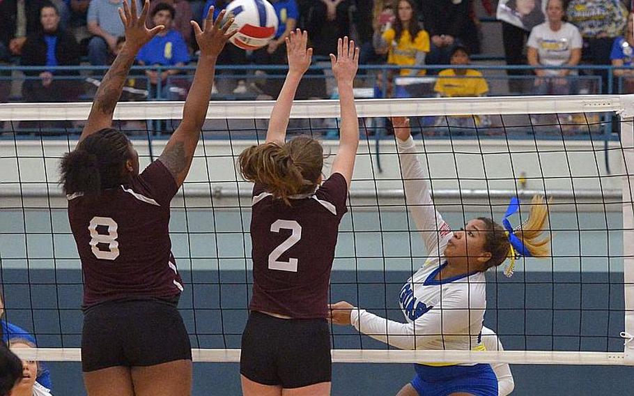 Sigonella's Kisiah Chandler, right, hits the ball over the net against Baumholder's Eliyah Tillman, left, and Annabel Brinkmeyer in Sigonella's 25-11,25-21, 2516 win in the Division III title game at the DODEA-Europe volleyball championships in Kaiserslautern, Germany, Saturday, Nov. 5, 2016. Chandler was named the D III tourney MVP.