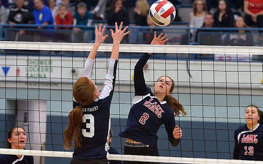 Bitburg's Hannah Bissonnette hits the ball over the net against the defense of Black Forest Academy's Kristen Jolly in the Division II final at the DODEA-Europe volleyball championships in Kaiserslautern, Germany, Saturday, Nov. 5, 2016. Bitburg took the title with a 25-15, 25-16, 25-11 win.