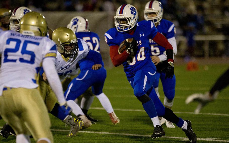 Ramstein's Marlon Guyton runs for a hole in Wiesbaden's defense at Vogelweh, Germany, on Saturday, Nov. 5, 2016. Ramstein won the DODEA-Europe Division I championship 13-8.