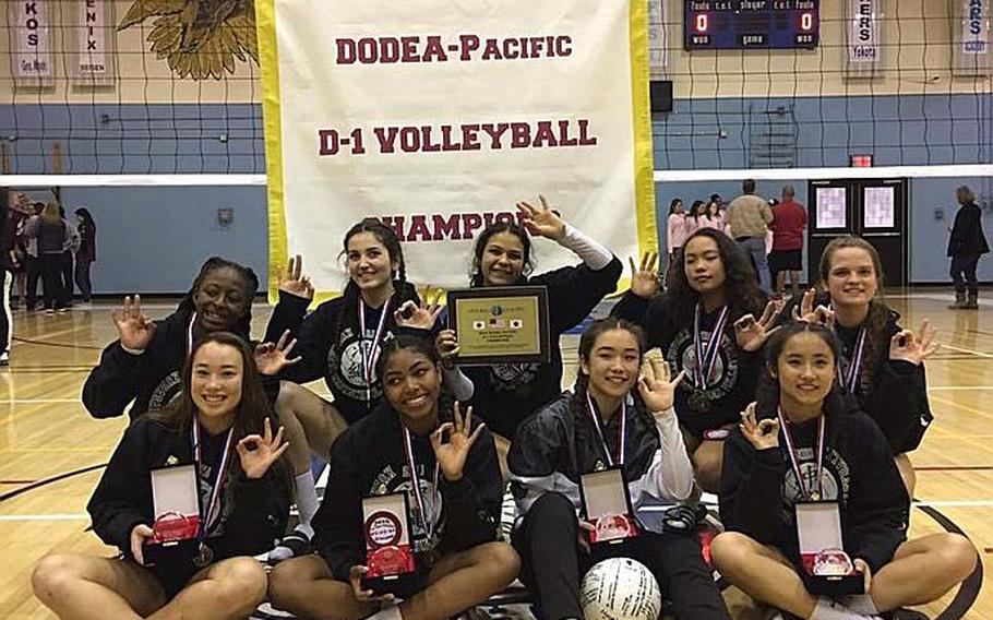 Kubasaki Dragons players show the No. 3 sign symbolic of their historic Far East High School Division I Volleyball Tournament title three-peat. Front row from left, Best Defender Jordyn Deleon Guerrero, Best Server Alanna Stein, MVP Maiya Larry, Best Setter Mimi Larry. Back row from left, Makayla Shepherd, Donatella Barone, Sammie Hernandez, Jenna Deleon Guerrero and Chloe' Stevens.