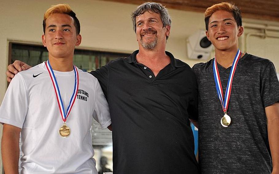 Leon Hoy and Noah Inahara of American School In Japan, Far East tennis tournament boys doubles champions, with tournament director Ed Thompson. Inahara also won the singles title.
