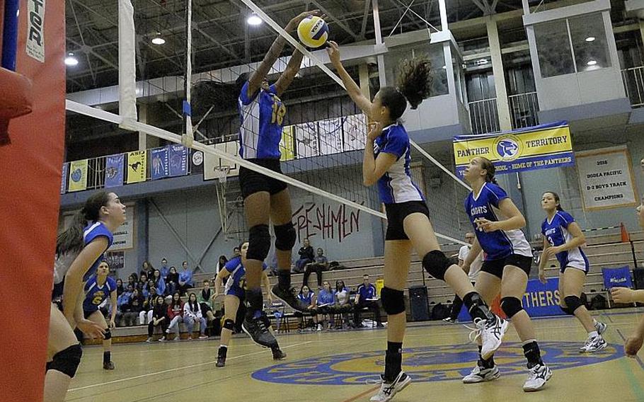 Yokota's Britney Bailey blocks CAJ's Annabelle Deakin's shot during the Far East Division II Volleyball championship match Thursday at Yokota Air Base, Japan. The Panthers defeated Christian Academy of Japan 25-11, 25-23, 25-23 claiming the school's first Far East volleyball crown.