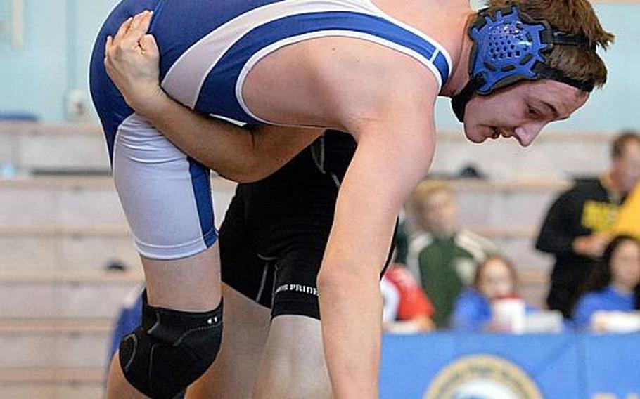 Daegu senior Jake Dexter, executing a throw on Yokota's Cameron Ewens during last Saturday's "Beast of the Far East" tournament, says he has tried to talk 10 of his classmates into coming out for wrestling and at least five have said no, simply because they didn't want to wear a singlet.