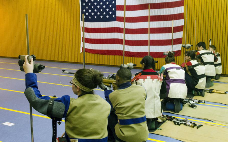 Varsity shooters from Wiesbaden, Kaiserslautern and Baumholder prepare to fire from the kneeling position during a conference marksmanship competition in Wiesbaden, Saturday, Jan. 21, 2017.