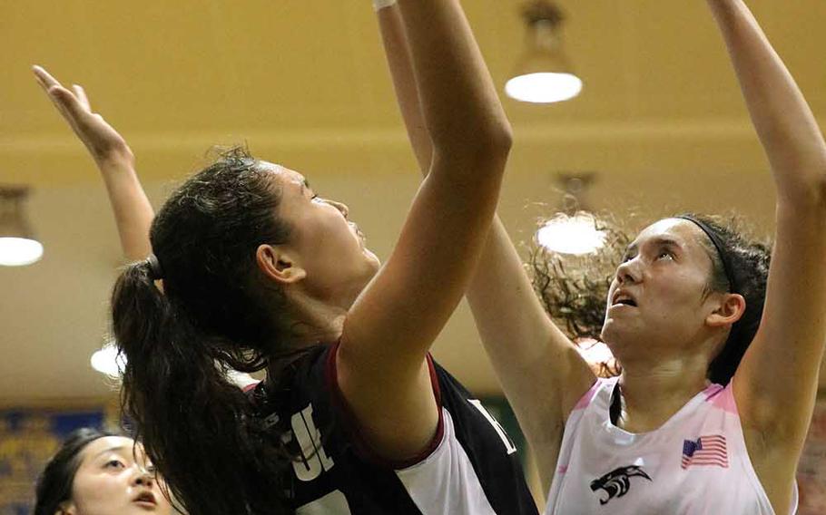 American School of Bangkok's Neeltje Hendriske and Kadena's Saj McBurrows battle for the ball during Thursday's Far East Girls Division I Tournament final. The Eagles dethroned the Panthers 52-31.
