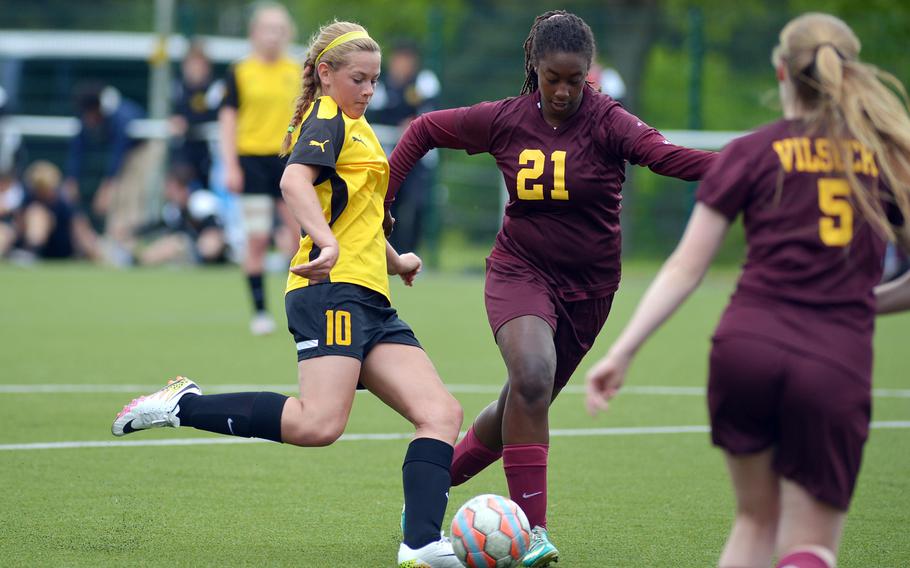 Stuttgart's Lexi McLellan gets off a shot against Vilseck's Marquita Morris, center and Margaret Clearwater in a Division I game on opening day of the DODEA-Europe soccer championships in Reichenbach-Steegen, Germany, Wednesday, May 18, 2016.