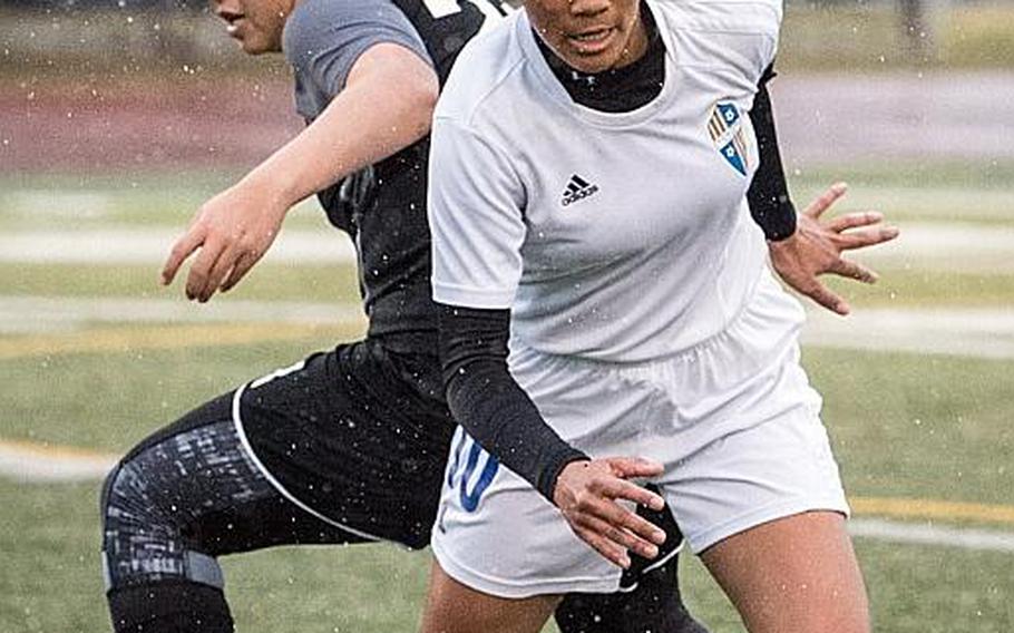 Yokota's Ai Robbins, battling for the ball with Zama's Reagan Palmer, is one of three juniors whom Panthers coach Matt Whipple calls the "strike force" for the two-time defending Far East Division II tournament champions.