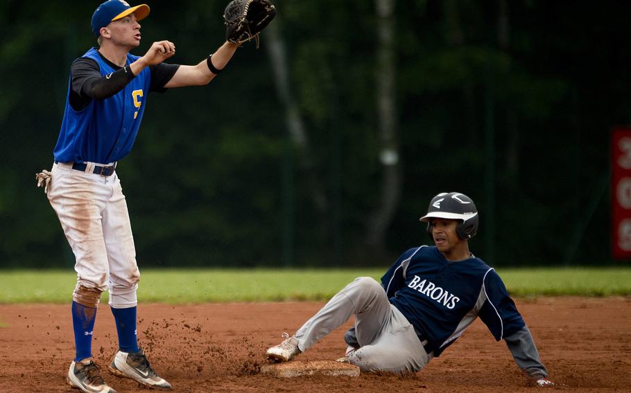 Sigonella's Austin Brehmer, left, jumps for the ball as Bitburg's Tyriq Zvijer slides into second during the DODEA-Europe baseball tournament in Kaiserslautern, Germany, on Friday, May 27, 2016.
