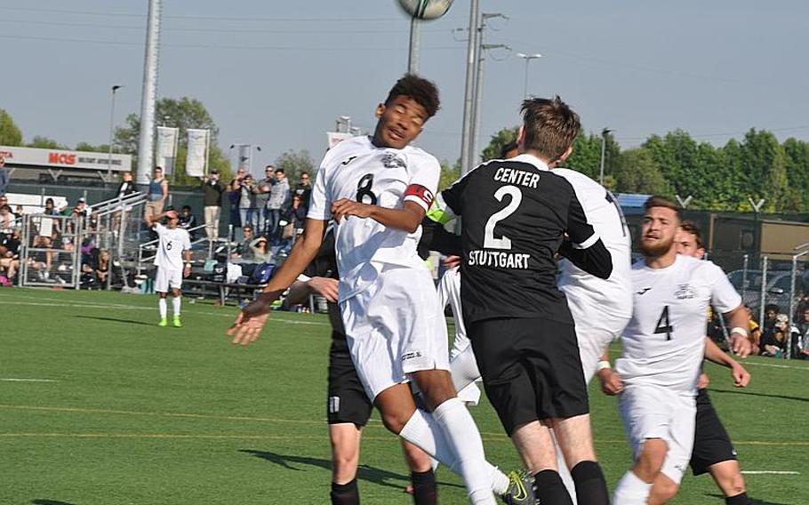 Naples' Nate Stewart, who scored two goals, heads the ball toward the net while Stuttgart's Ethan Center defends in the Wildcats 2-1 victory Friday.