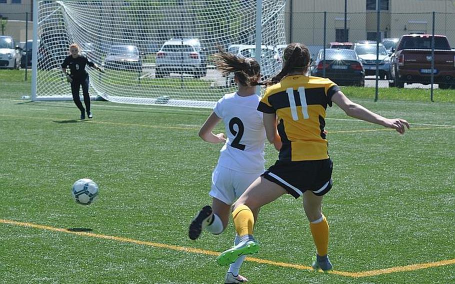 Stuttgart's Janey Greenberg and Naples' Abigail Houseworth watch Greenberg's kick sail toward Naples goalkeeper Katherine Abresch.