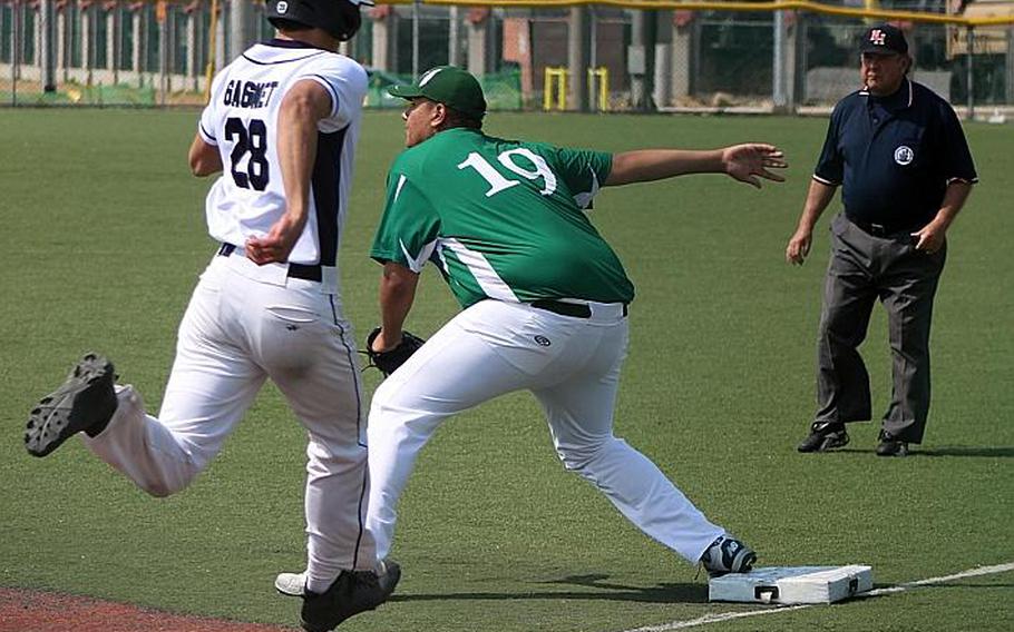 Daegu first baseman Elijah Bembishew awaits the throw as Seoul American's Joshua Gagnet strains to reach the bag during Saturday's DODEA-Korea baseball game, won by the Falcons 13-2.