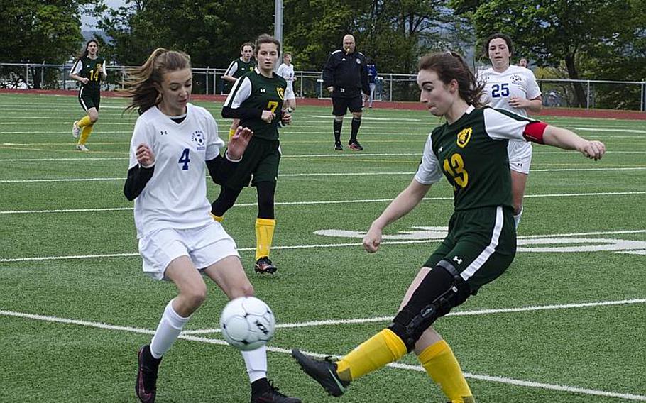 SHAPE defender Quinn Kilrain clears the ball under a challenge from Wiesbaden's Lily Hogenson during their match Saturday, April 22, 2017, in Wiesbaden, Germany. Despite a strong performance from Kilrain, who also took SHAPE's free kicks, the hosts triumphed 2-0.