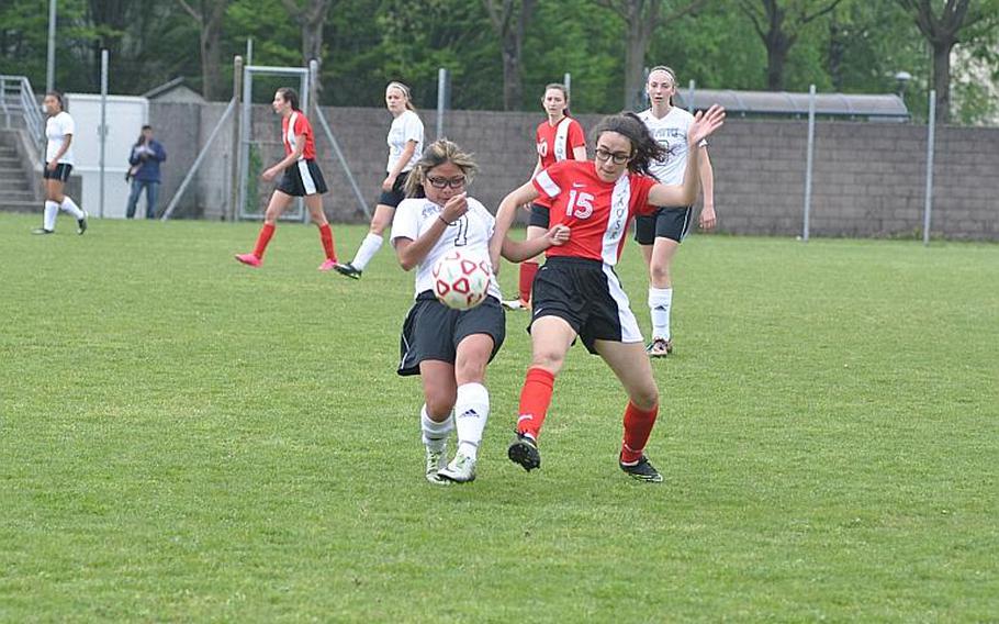 Aviano's Kirshten Masiclat and American Overseas School of Rome's Maria Rossi battle for the ball Saturday in the Saints' 4-3 victory.