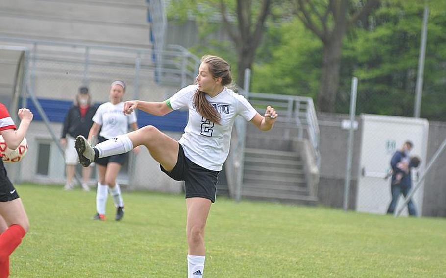Aviano junior Hailey Pulliam, who scored all four of her team's goals Saturday - kicks the ball away in the midfield in the Saints 4-3 victory over American Overseas School of Rome.