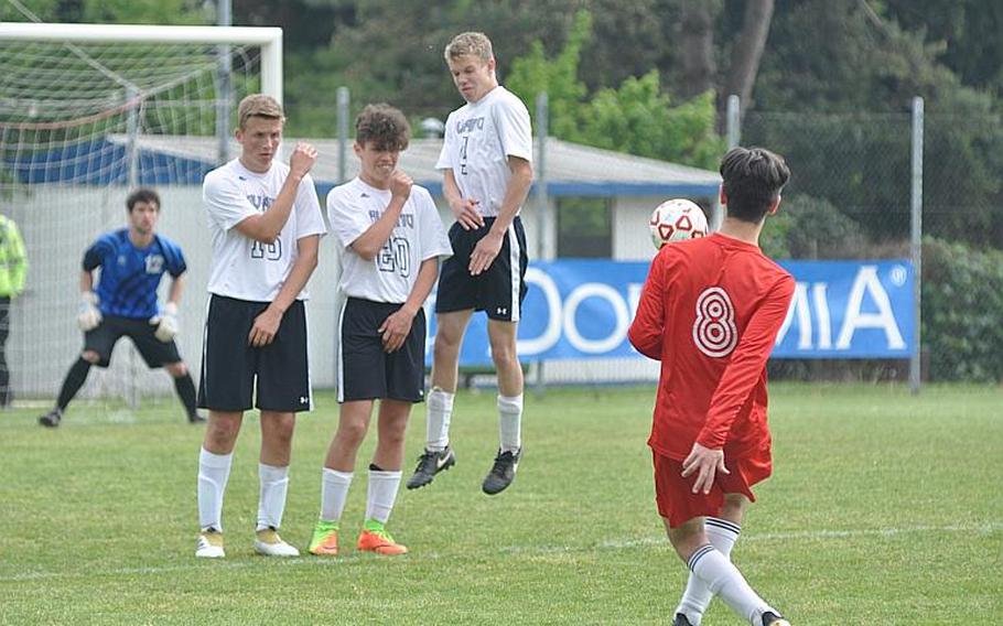 American Overseas School of Rome's Bar Poleg tries to shoot around an Aviano wall of defenders Saturday as the two teams battled to a 0-0 draw.
