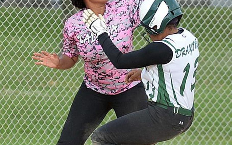 Kubasaki baserunner C.C. Charles chugs into third base ahead of the throw to Kadena third baseman Briana Wilson during Friday's Game 2 of the Okinawa district softball finals, won by the Dragons 8-4 to complete a two-game sweep.