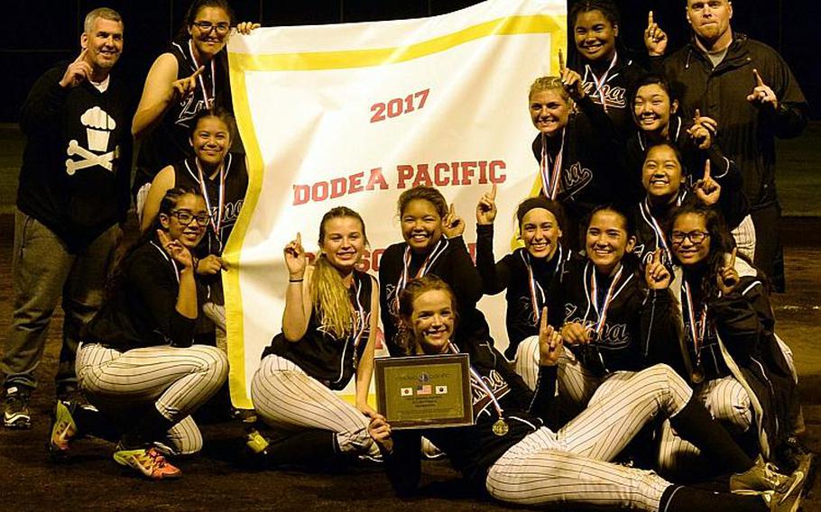 Zama players and coaches gather round the banner after beating Yokota 13-3 in the third of three Far East Division II Softball Tournament final games on Wednesday.

DAVE ORNAUER/STARS AND STRIPES