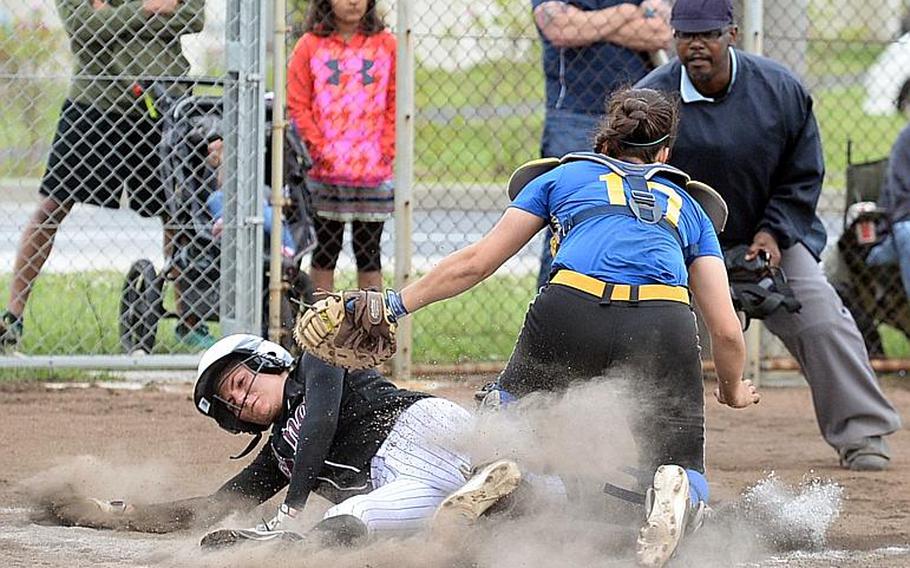 Zama's  Ally Chiarenza gets tagged out by Yokota catcher Irene Diaz during Wednesday's final games in the Far East Division II Softball Tournament. Yokota won the first two 16-0 and 10-6 before Zama prevailed 13-3 in the third game for the Trojans' first title since 2012.

DAVE ORNAUER/STARS AND STRIPES