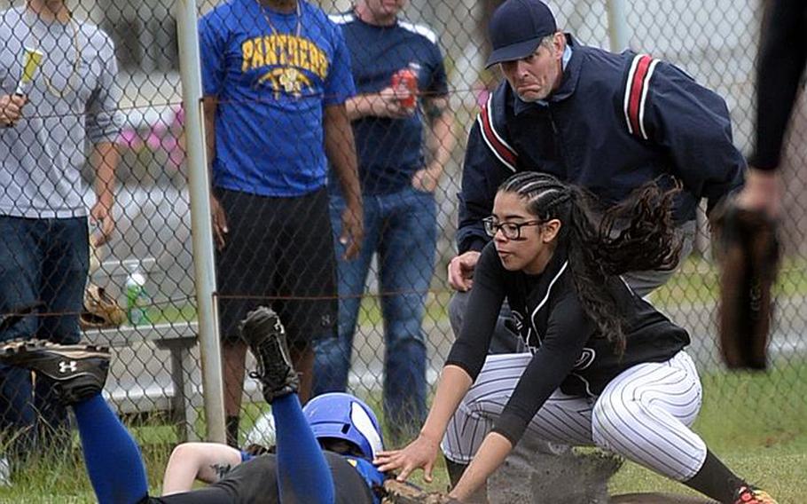 Zama third baseman Litzie Figueroa tags out Yokota's Sally Lambie during Wednesday's final games in the Far East Division II Softball Tournament. Yokota won the first two 16-0 and 10-6 before Zama prevailed 13-3 in the third game for the Trojans' first title since 2012.

ANGELA ROOT/SPECIAL TO STRIPES