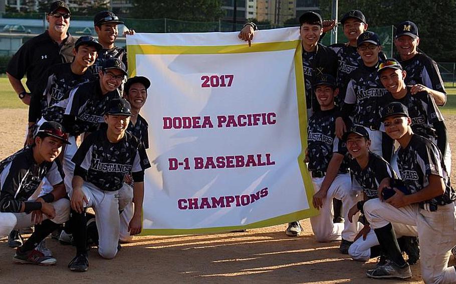 American School In Japan players and coaches gather round the banner after beating Kadena 5-4 for the Mustangs' fourth straight Far East Division I Baseball Tournament title.

WESTON GRAVES/SPECIAL TO STRIPES