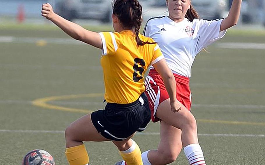 Nile C. Kinnick's Hannah Quejada and American School In Japan's Megumi Shimizu scuffle for the ball during Thursday's Far East Girls Division I Soccer Tournament final, won by the host Red Devils 3-0.

DAVE ORNAUER/STARS AND STRIPES