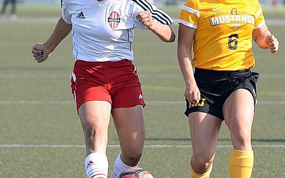 Nile C. Kinnick's Cassie Medel shoots past American School In Japan's Megumi Shimizu during Thursday's Far East Girls Division I Soccer Tournament final, won by the host Red Devils 3-0.

DAVE ORNAUER/STARS AND STRIPES