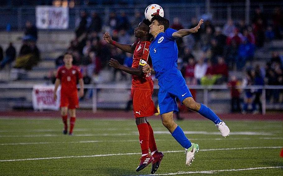 Kaiserslautern's Alexander Dexter, left, and Ramstein's Gerald Donohue jump for a header during the DODEA-Europe Division I championship in Kaiserslautern, Germany, on Saturday, May 20, 2017. Kaiserslautern won the title match 3-1.