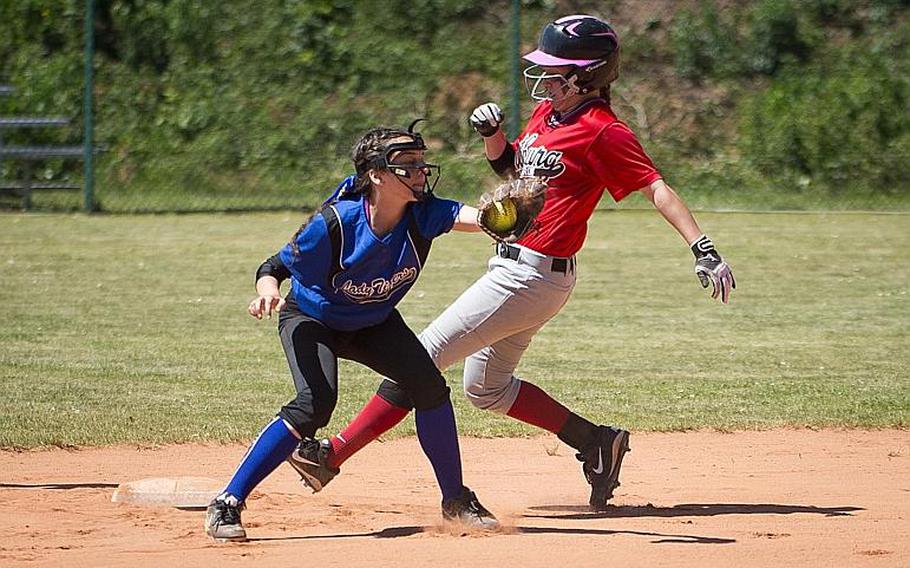 Bitburg's Alicia Paul, right, runs to third ahead of a throw to Hohenfels' Aliyah Jordan during the DODEA-Europe softball tournament at Ramstein Air Base, Germany, on Friday, May 26, 2017. Bitburg won the Division II/III game 10-4.

MICHAEL B. KELLER/STARS AND STRIPES