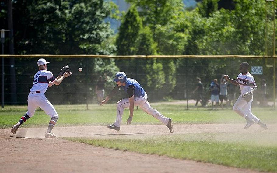 Sigonella's Alex Ogletree dives to get out of a pickle between Bitburg's Max Little, left, and Jermaine Cooks Jr. during the DODEA-Europe Division II/III baseball championship at Ramstein Air Base, Germany, on Saturday, May 27, 2017. Sigonella won the game 10-1.

MICHAEL B. KELLER/STARS AND STRIPES