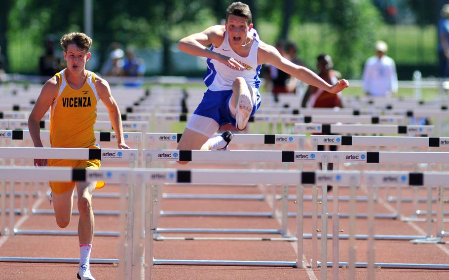 Wiesbaden's Garrett Armel clears a hurdle on his way to winning the 110-meter event in 15.82 seconds at the DODEA-Europe track and field finals in Kaiserslautern, Germany, Saturday, May 27, 2017. At left is Vicenza's Dawson Merkel who came in second.