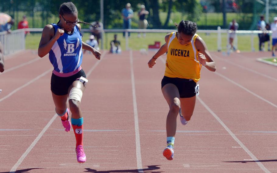 Brussels' Tariziana Thompson, left, beats Vicenza's Brandy James to the finish line in the 100-meter dash at the DODEA-Europe track and field finals in Kaiserslautern, Germany, Saturday, May 27, 2017. Thompson won in 12.75 seconds ahead of 12.83 for James.